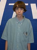 Adam posing for a photograph in Newtown High School around 2007/2008. The wall behind has the letters NTV, which was the name of the school's local TV channel run by the tech club. Lanza worked as a cameraman for the channel.