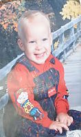 Adam posed for a baby photo in front of an autumn themed background. Source: Lanza Home Backup Scene 489.