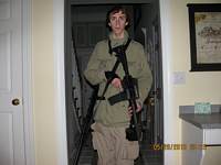 Photo taken by Adam (using a timer) at his home in 36 Yogananda Street in 2010, in which he can be seen posing with his Bushmaster Rifle used in the shooting. The photo was taken 18-05-2010 at 11:25pm.